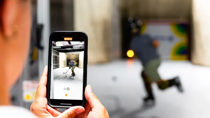 A parent films a skater's rep on a phone at the Lab