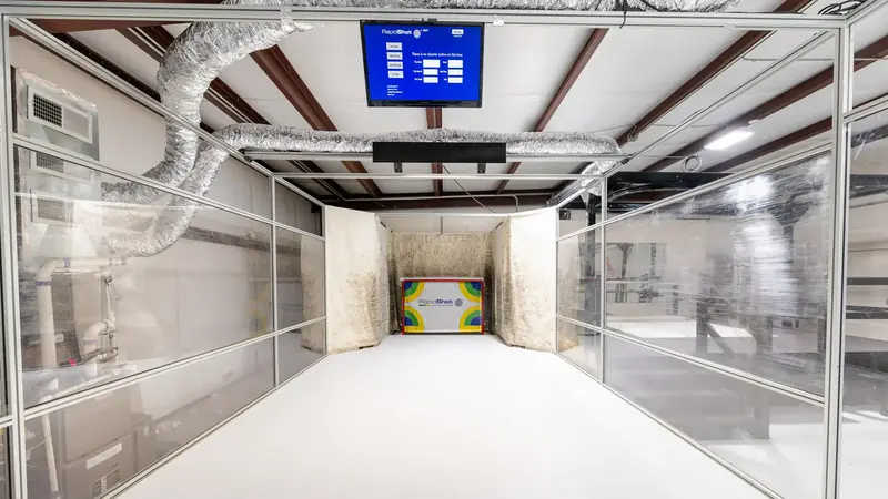 Looking down the enclosed RapidShot Pro lane toward the target board and stats screen